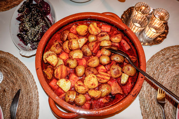 Stockholm, Sweden A stew with grilled potatoes and wine and carrots and pork.