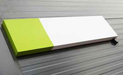 White and green blank plate on striped metal wall