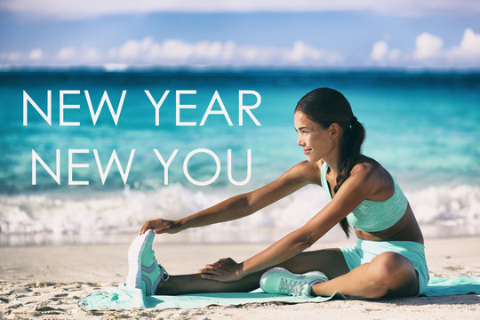 New Year new you motivational quote message on beach background. Asian woman training stretching on yoga mat for fitness resolution goal.