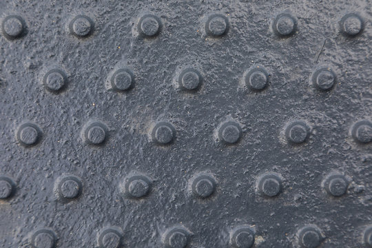 Close-up of shiny dark tactile surface with pimps