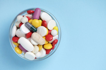 A bowl with colorful medicine pills	