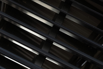 Close-up of a black ventilation grille with gaps - obrazy, fototapety, plakaty
