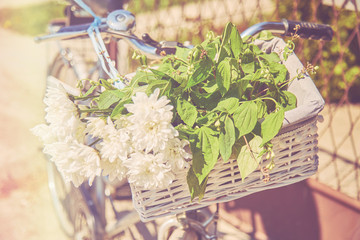 Old retro bicycle with flowers and balloons outdoors.