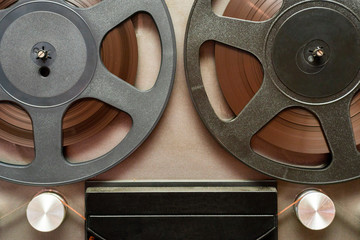 Vintage tape recorder is playing music, close up. Vintage tape recorder roller