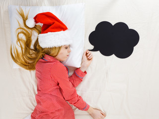 Sleeping woman wearing pajamas and Santa Claus hat