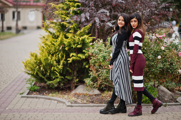 Portrait of two young beautiful indian or south asian teenage girls in dress.
