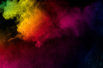 Obraz na płótnie Canvas Colorful background of pastel powder explosion.Rainbow color dust splash on black background.