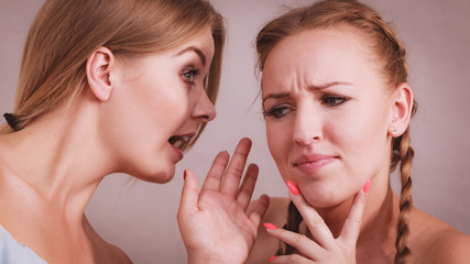 Two teen women gossiping
