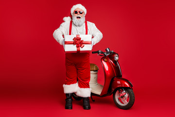 Full length body size view of his he nice bearded cheerful funky Santa hipster standing near motor...