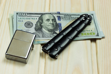 knife and a lighter next to money, concept, crime, contract kill	