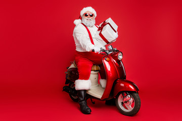 Portrait of his he nice bearded cheerful fat funky Santa hipster sitting on motor bike holding in...