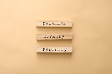 Wooden calendar winter months on wooden cubes. Top view Flat Lay Minimal