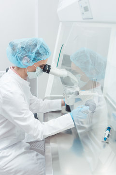 Scientist in lab conducting biotechnological experiment