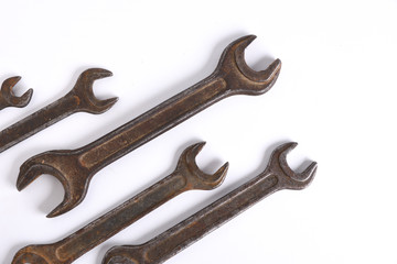 Old rusty stainless steel crescent wrench isolated on white top view