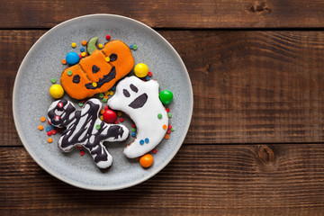Halloween cookies on wood background, flat lay