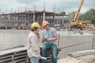 Two young man architect on a building construction site