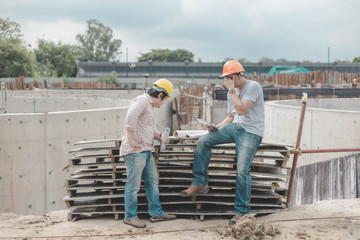 Two young man architect on a building construction site