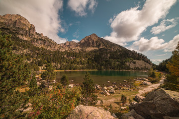 landscape with high mountain lake and blue sky with clouds