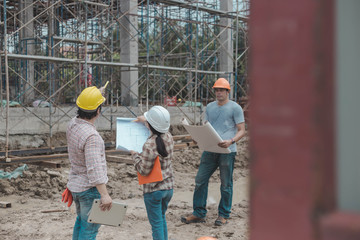 three construction engineers working together in construction site planning for the renovation
