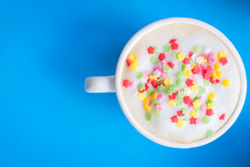 Party decorated coffee cups with foam and colored stars.