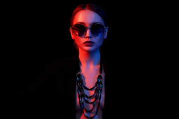 Fashion portrait of beautiful girl in sunglasses and jewelry