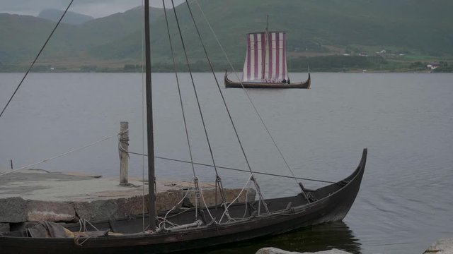 Harbour scene with Viking ship sailing by
