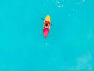 Attractive woman on stand up paddle board on a quiet blue ocean. Sup surfing in sea
