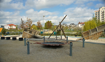 Fototapeta premium Children playground on yard in public park. Urban neighborhood childhood concept.