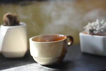 cup of tea and teapot on wooden table