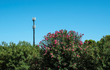 Telecommunication 5G transmitters. GSM antenna on blue sky.