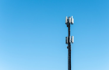 Telecommunication 5G transmitters. GSM antenna on blue sky.