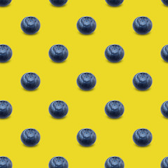 Blueberries on a yellow background.