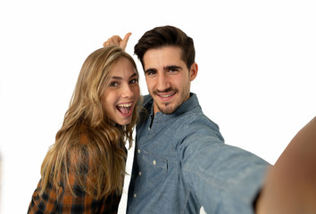 Stylish tourist couple taking pictures selfie on smart phone. romantic image isolated on white