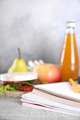lunch for your child in school, box with a healthy sandwich and fruit salad and apple juice in the bottle for drinking