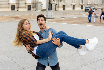Young crazy tourist couple on holidays having fun while traveling around Europe