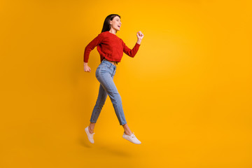 Fototapeta na wymiar Full body profile side photo of positive cheerful girl jump run hurry go after discounts feel content on autumn weekends wear good looking outfit isolated over bright color background