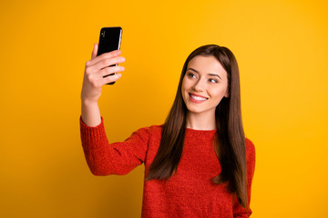 Photo of gorgeous cute fascinating charming girl taking selfie recording video smiling toothily isolated over yellow vivid color background