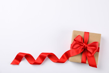 Beautiful gift box with red bow on white background, space for text