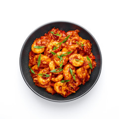 Schezwan Prawns isolated at white background. Schezwan Prawns is indo-chinese cuisine curry dish with prawns or shrimps and Schezwan Sauce.