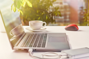 Laptop on a window background on a bright sunny day