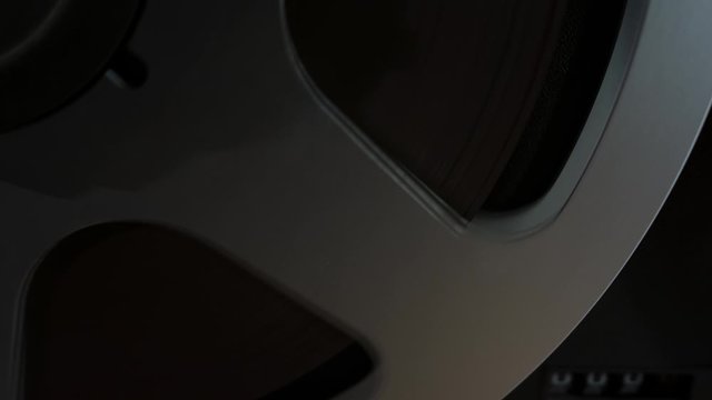  Retro Analog Quarter Inch Tape Recorder Being Operated in a Darkened Room