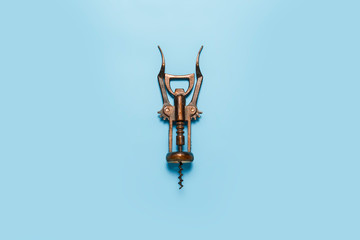 Metal retro corkscrew on a blue background. Flat lay, top view - obrazy, fototapety, plakaty