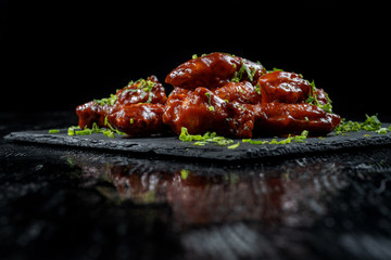 Chicken Wings with tomato barbecue sauce. Sprinkled with dill, onions and parsley.