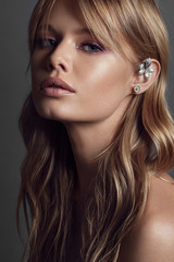 Beautiful young woman with kaffa in the ear. Make up and Jewelry concept - Image - 295810321