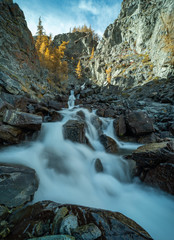 mountain river and waterfall on a background of autumn trees