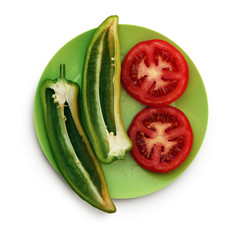 Peppers and tomato on the green plate