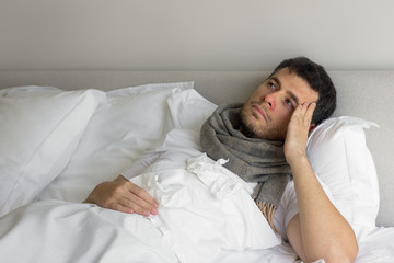 Man feeling bad lying in the bed