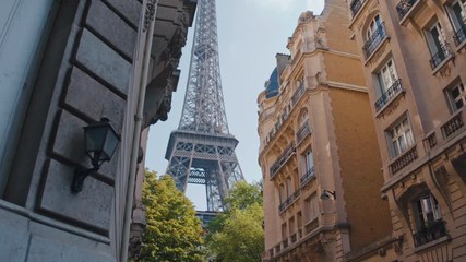 4K Eiffel Tower from a corner of an old street in Paris during daytime - Slow Motion