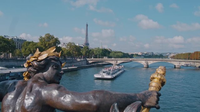 4K Seine river from Pont Alexandre III in Paris, the Eiffel tower in the background and a boat crossing the river during daytime - Slow Motion