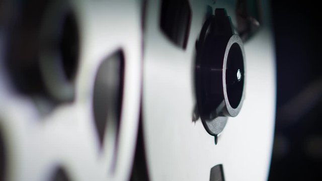  Retro Analog Quarter Inch Tape Recorder Being Operated in a Darkened Room
